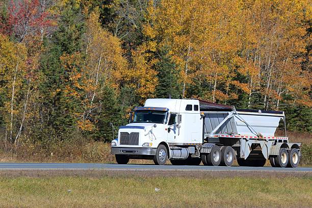 istock Semi Tractor Trailer on Interstate Highway, trees in background. 619770698