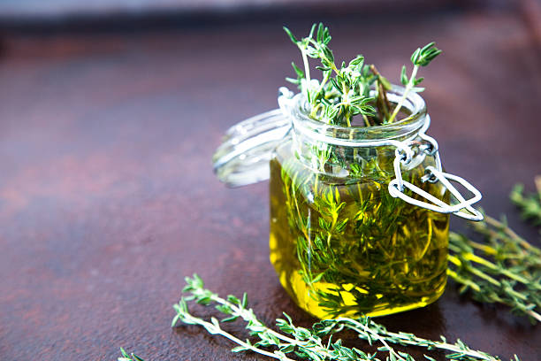 istock Thyme oil. Thyme essential oil jar glass bottle 619770762