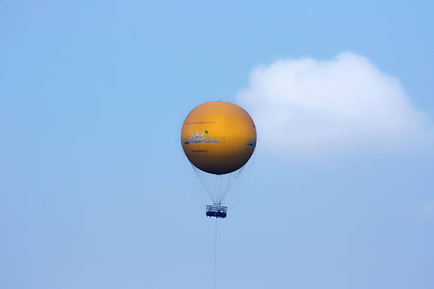 Siem Rep, Cambodia - April 12 2009: Hot air balloon filled with tourists contemplating from the sky the UNESCO World Heritage Site of Angkor.