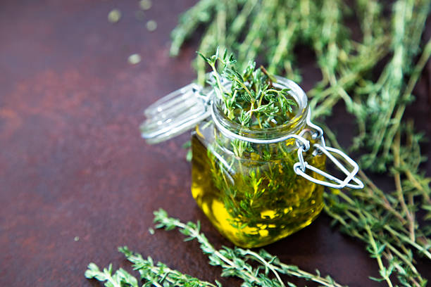 istock Thyme oil. Thyme essential oil jar glass bottle 619771042