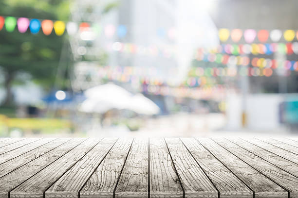 istock Empty wooden table with party in garden background blurred. 619771266