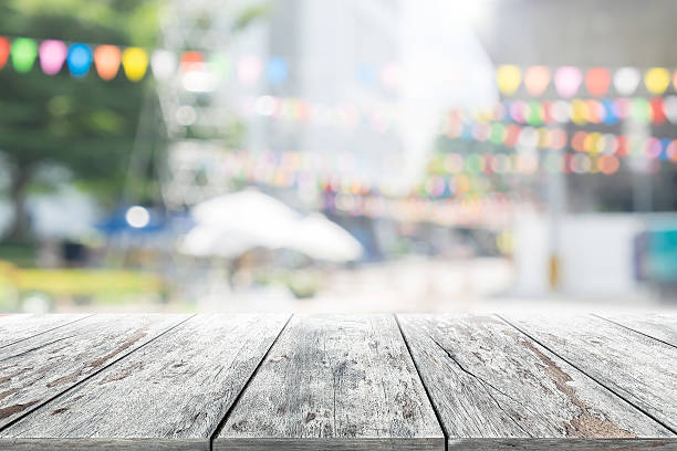 istock Empty wooden table with party in garden background blurred. 619771376