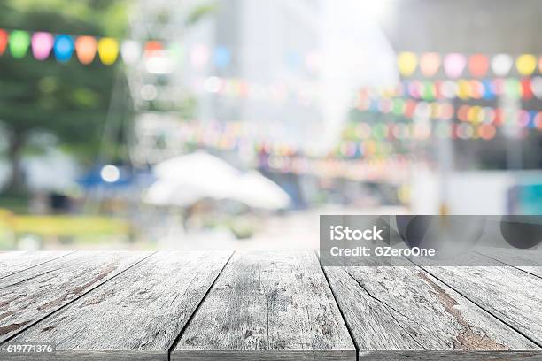 Empty Wooden Table With Party In Garden Background Blurred Stock Photo - Download Image Now