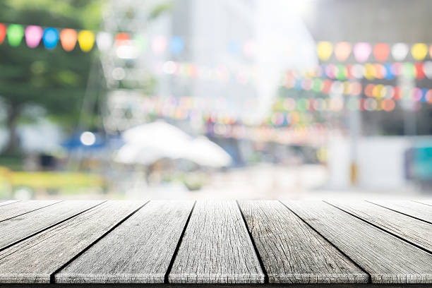istock Empty wooden table with party in garden background blurred. 619771486