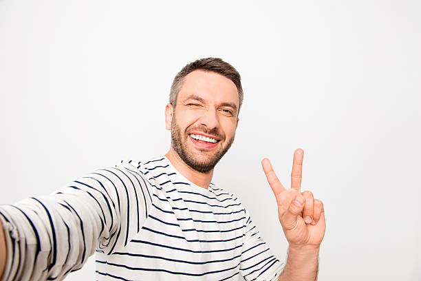 istock Happy man making selfie and showing two fingers 619771896