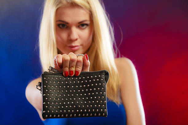 istock Elegant woman holds black handbag 619773158