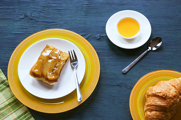 Fruit cake with honey and croissant on a blue wooden