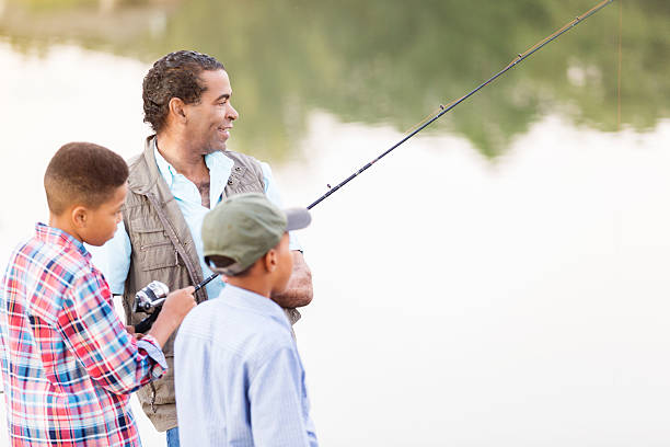 istock Grandfather bonds with grandsons while fishing 619774376