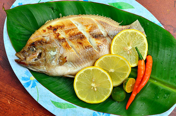 istock Grilled Tilapia with lemon and chili on banana leaves 619774826