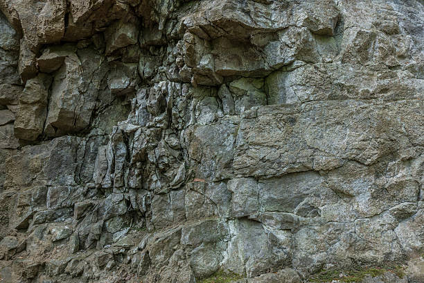 istock The stone wall of rock with cracks 619960960