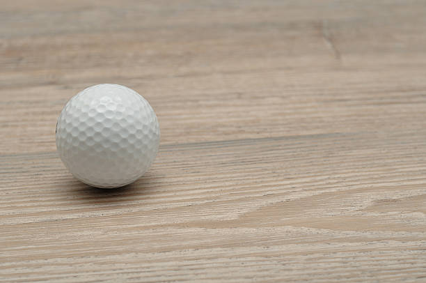 istock Golf ball isolated on wooden background 619962712