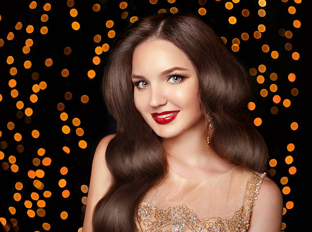 istock Makeup. Elegant wavy hairstyle. Beautiful brunette smiling 619963794