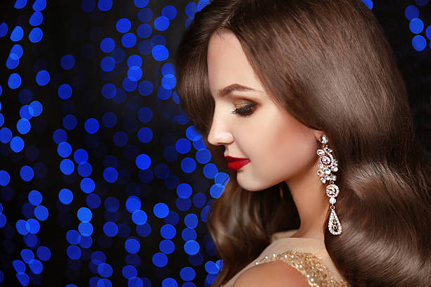 istock Makeup. Fashion earrings. Beautiful brunette elegant model 619963864