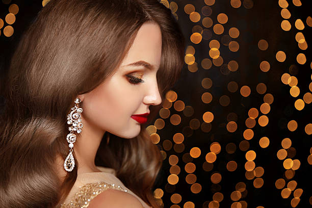 Makeup. Jewelry. Beautiful smiling woman model
