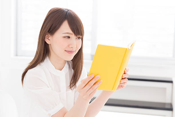 istock Japanese woman reading a book 619964372
