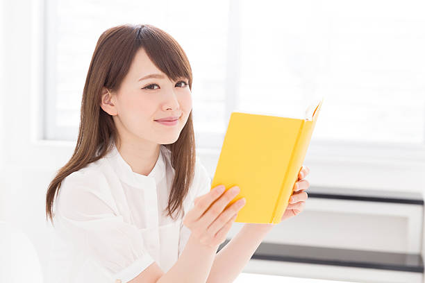 istock Japanese woman reading a book 619964400