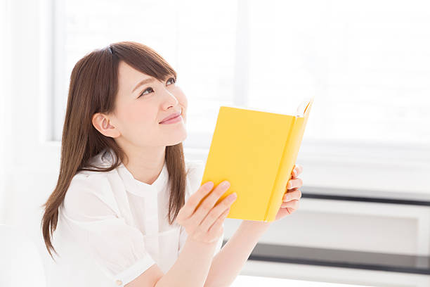 istock Japanese woman reading a book 619964468