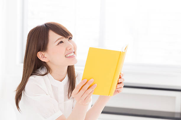 istock Japanese woman reading a book 619964494