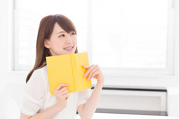 istock Japanese woman reading a book 619964516