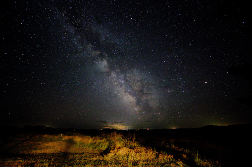 Spectacular starry sky of the Milky Way Galaxy illuminates the horizon in South Dakota. Long exposure astrophotography.  