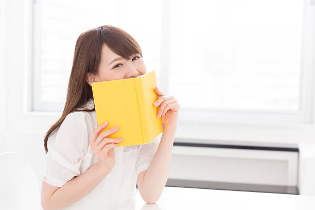 istock Japanese woman reading a book 619964604