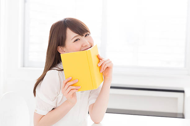 istock Japanese woman reading a book 619964630