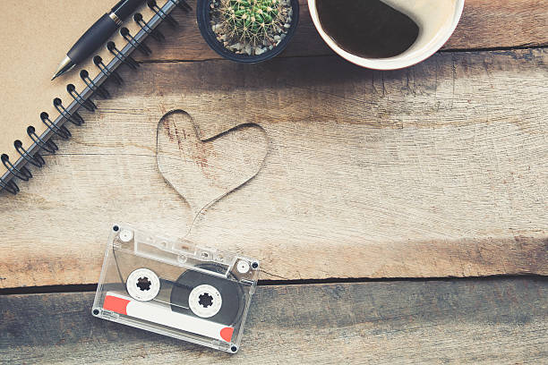 istock Cassette tapes shaping a heart on wooden table.vintage effect. 619964924