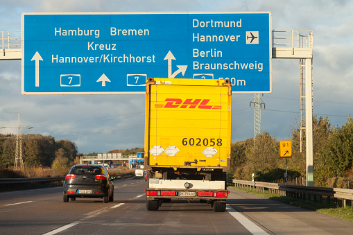 Hannover, Germany - November 2, 2016: international parcel service DHL truck, drives on german freeway A 7 near Hannover / Germany.