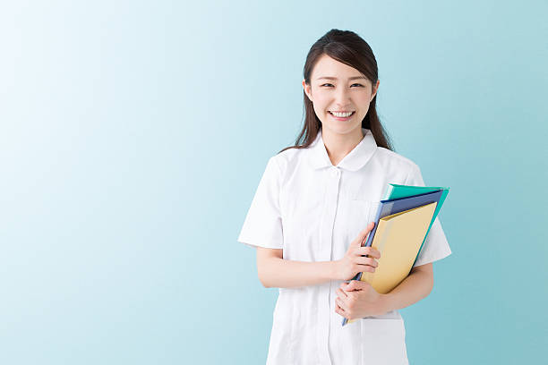 Nurse holding folders stock photo