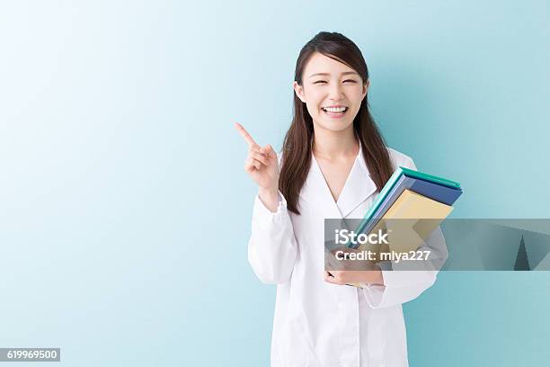 Doctor Holding Files Stock Photo - Download Image Now - Women, Lab Coat, Doctor