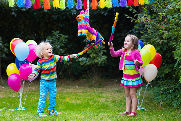 istock Kids playing with birthday pinata 619969782