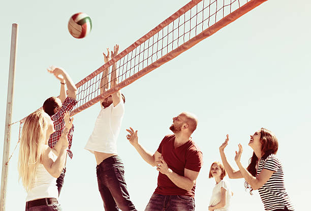 Friends playing volleyball at beach