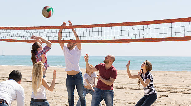 istock Friends playing volleyball at beach 619970686