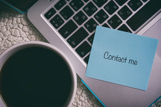 istock laptop, a cup of black coffee, blue paper sticker 619971768