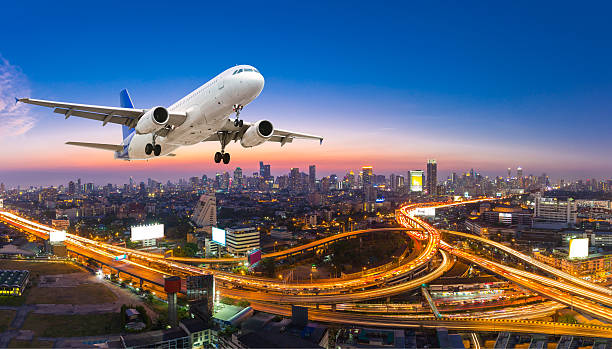 istock Airplane take off over the panorama city at twilight scene 619971774
