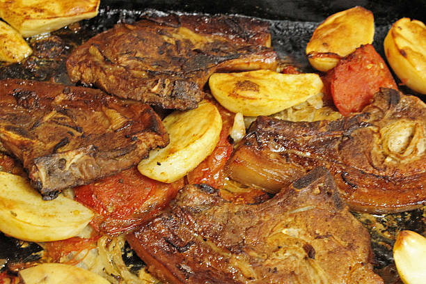 istock Oven baked pork chops with potatoes and tomatoes 619972058