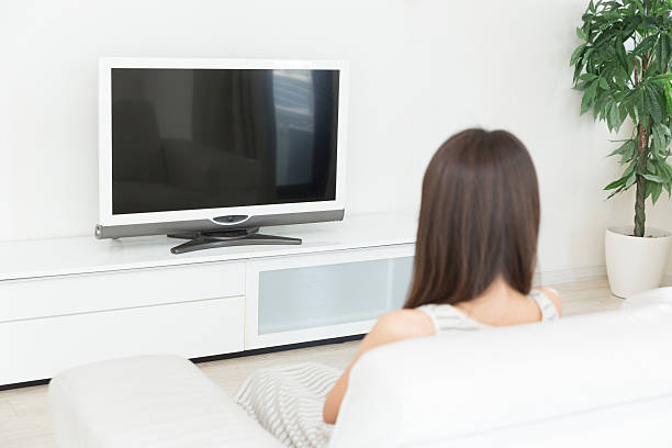 istock Woman watching television 619973592