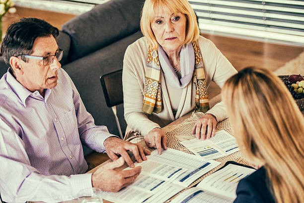 istock Mature couple inquiring about insurance plan 619973812