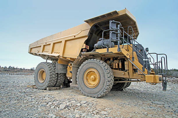 istock Oversized Dump Truck Parked On New Road Construction Site 619974414