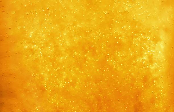 bolle che galleggiano nel liquido - defocused illuminated glitter orange foto e immagini stock