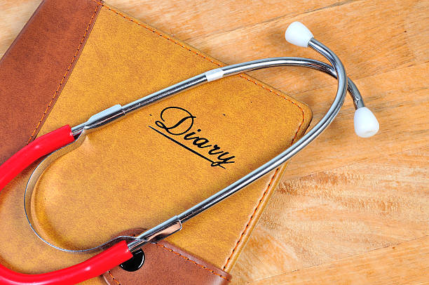 istock Stethoscope With Note Book and Pen On Wooden Table 619976680