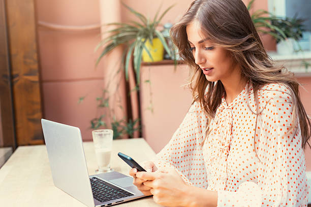 istock Young woman texting at the cafe 619978296