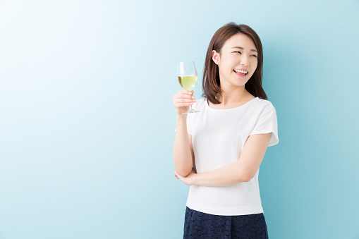 Japanese woman holding a glass of wine
