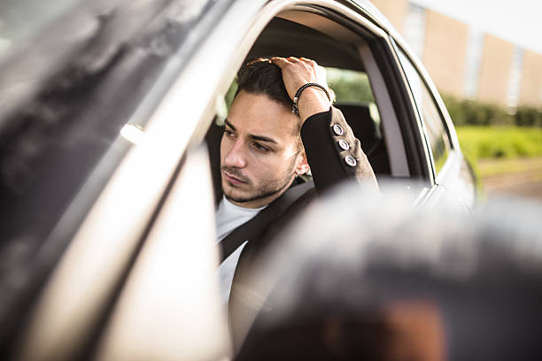 istock fashion man driving a black car 619979162