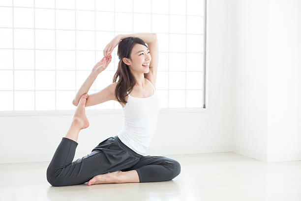 Woman stretching Woman stretching yoga studio photos stock pictures, royalty-free photos & images