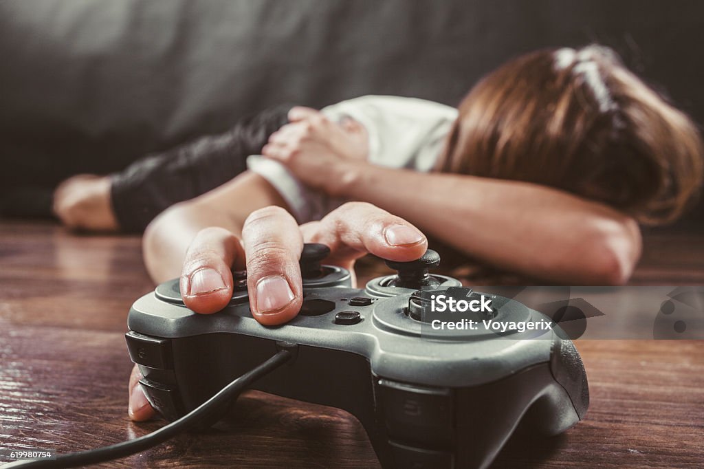 Young man with pad Addiction and dependency concept. Young man with pad joystick playing games. Male addicted to console videogames. Video Game Stock Photo