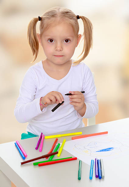 istock The girl draws with markers 619981244