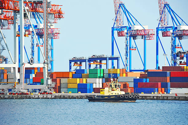 istock Tugboat and port cargo crane 619981374