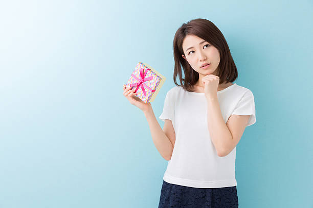 istock Japanese woman holding a gift box 619982168