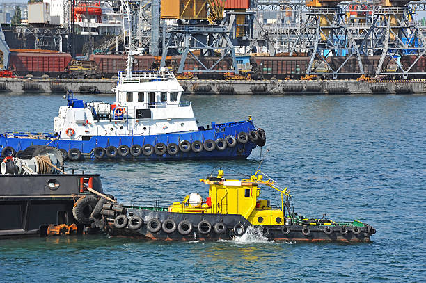 istock Tugboat and port cargo crane 619985930